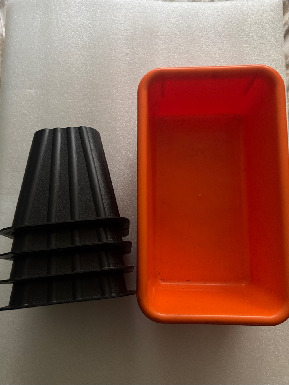 Bed risers and orange plastic container